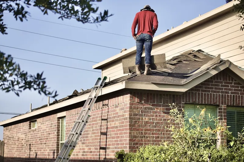 Professional roofer working on a residential roof in Maple Grove Park